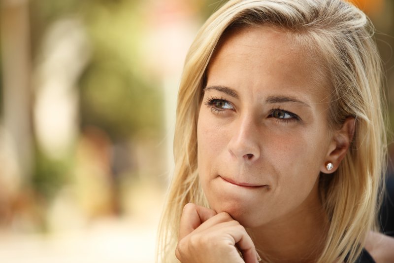 woman thinking hand on chin